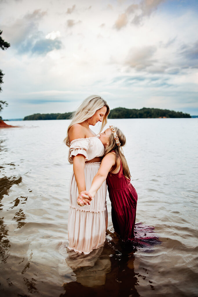 Family Photography, mother and daughter standing in lake together with long flowing dresses